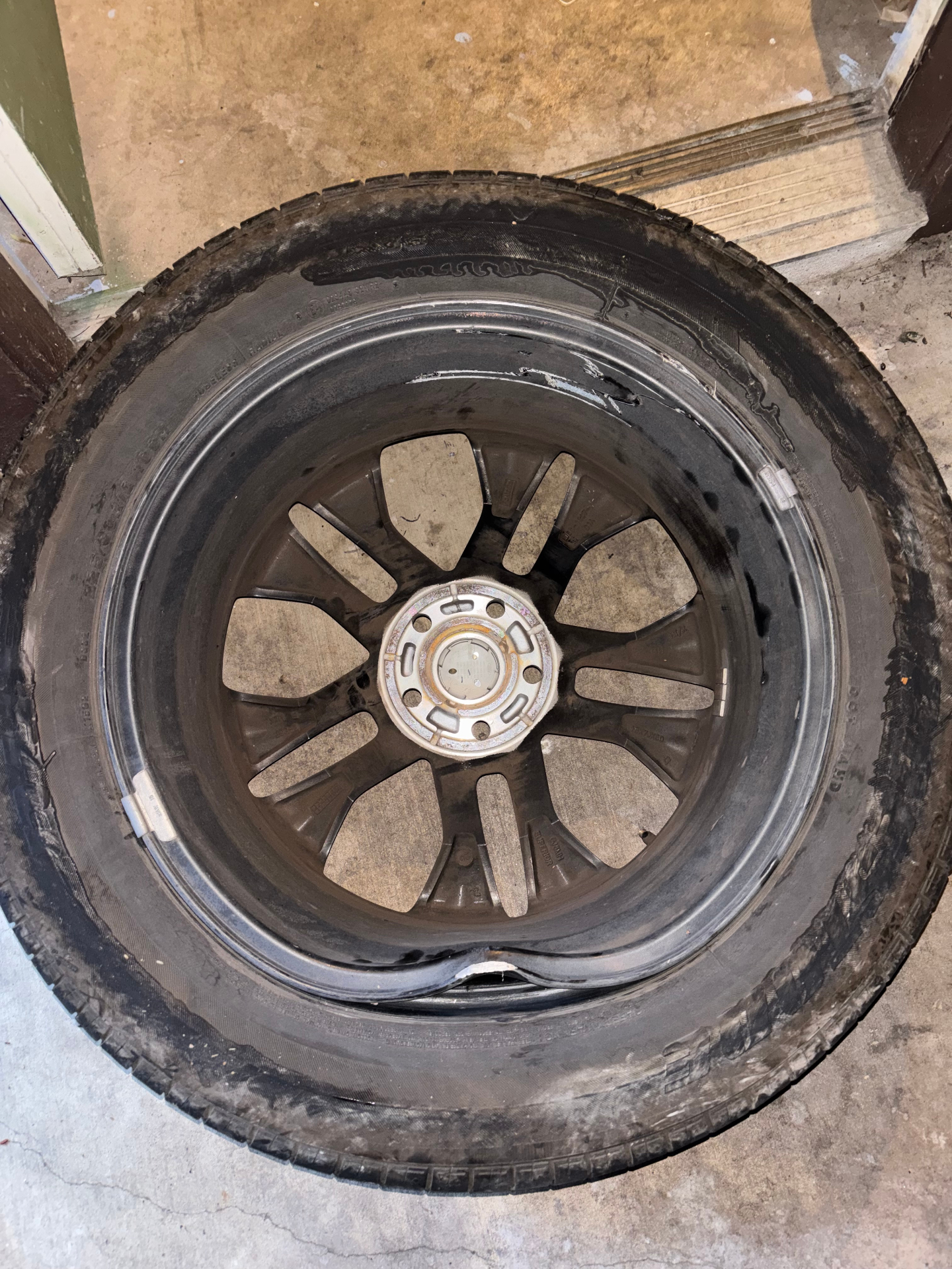 Severely bent wheel and destroyed tire viewed from the inside barrel