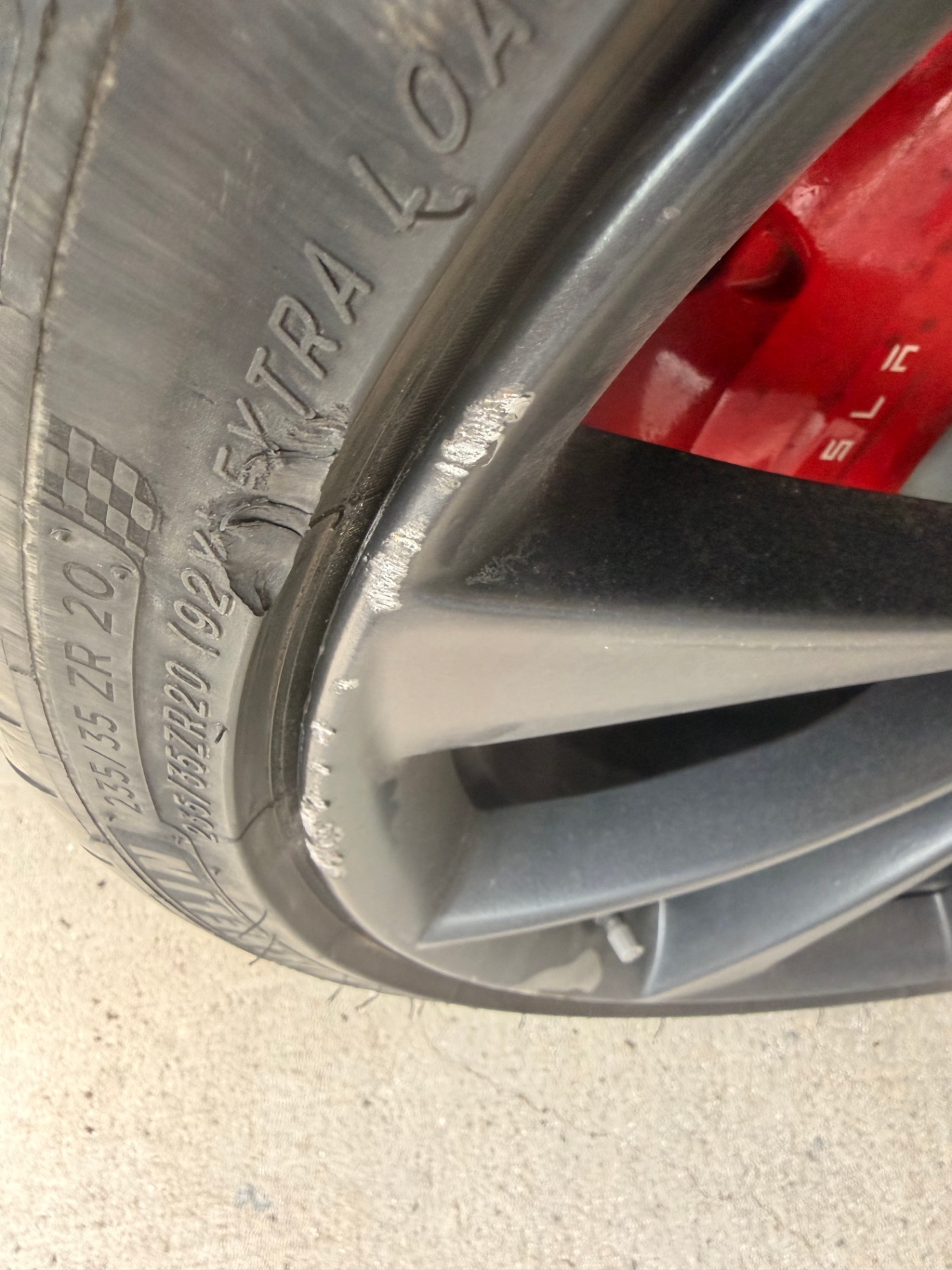 Heavily curbed two-tone wheel with shredded tire sidewall